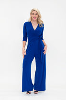 Female model in cobalt blue wrap jumpsuit. Front view