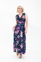 Model wearing the Hazel floral wrap dress by By Samantha Melbourne. Curve-friendly fit with a deep navy base and pink botanical print.