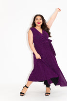 Wrap dress is available in regular and plus size dress options  metallic purple sparkly dress