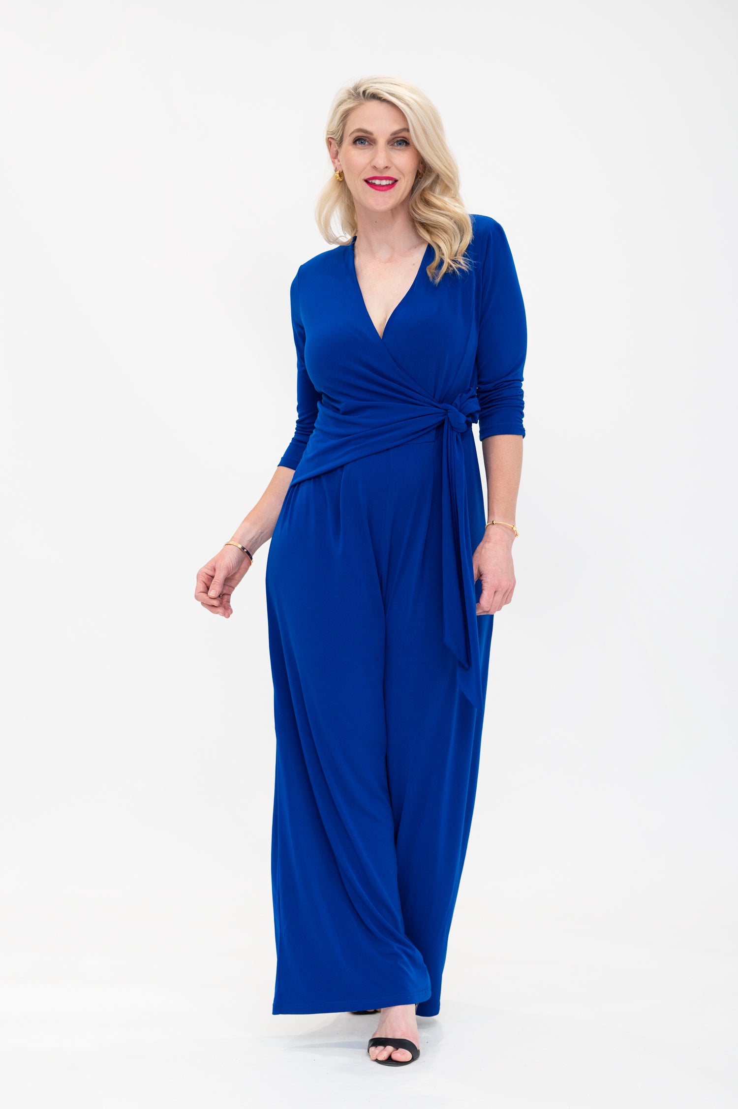 Female model in cobalt blue wrap jumpsuit. Front view