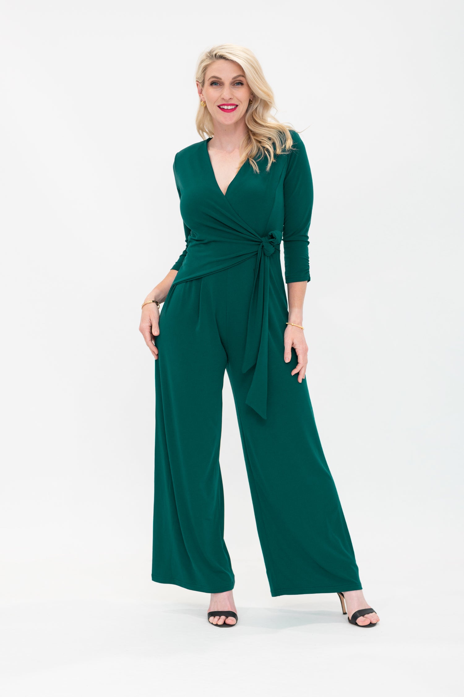 Female model in green wrap jumpsuit. Front view
