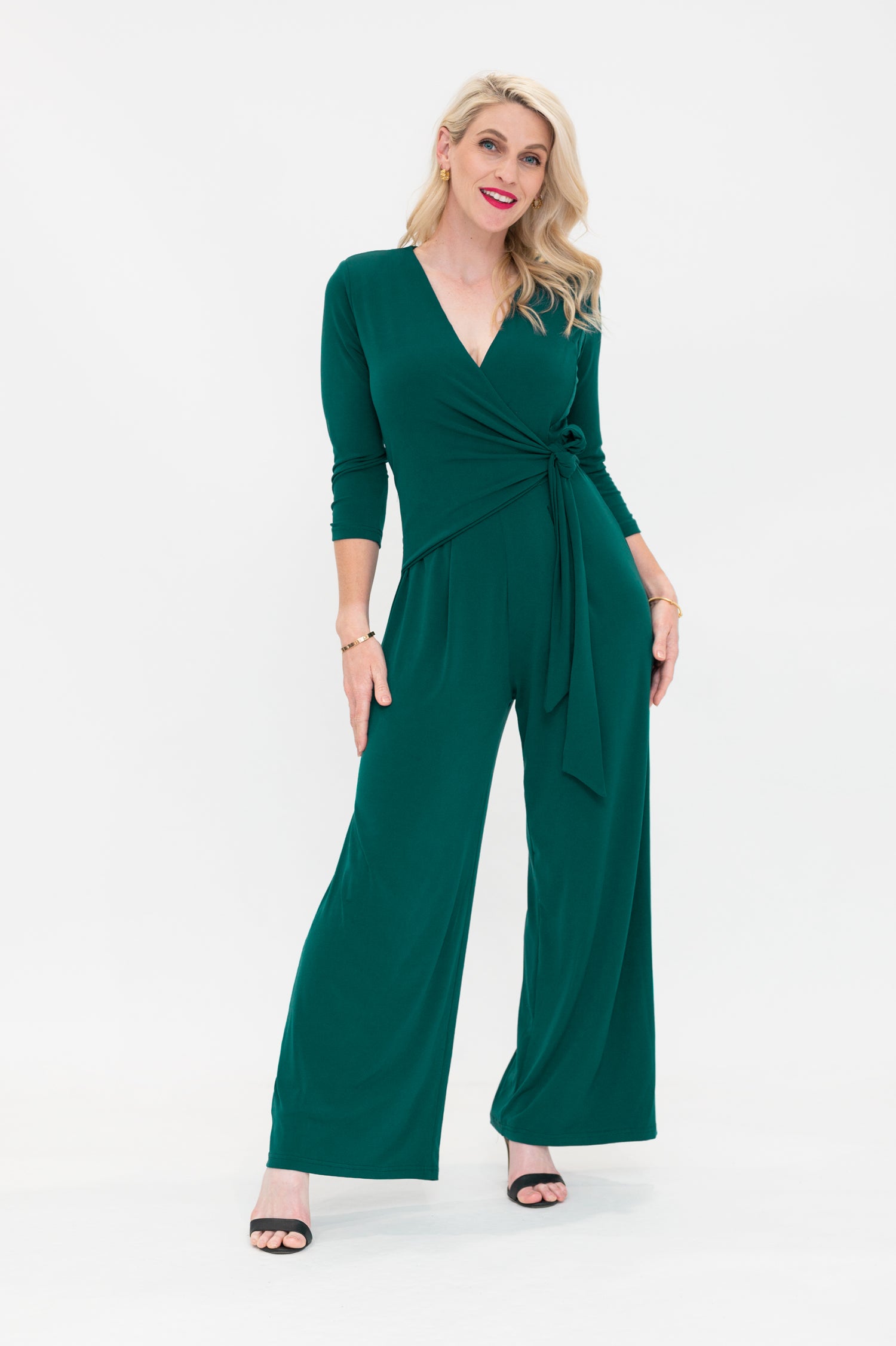 Female model in green wrap jumpsuit. Front view