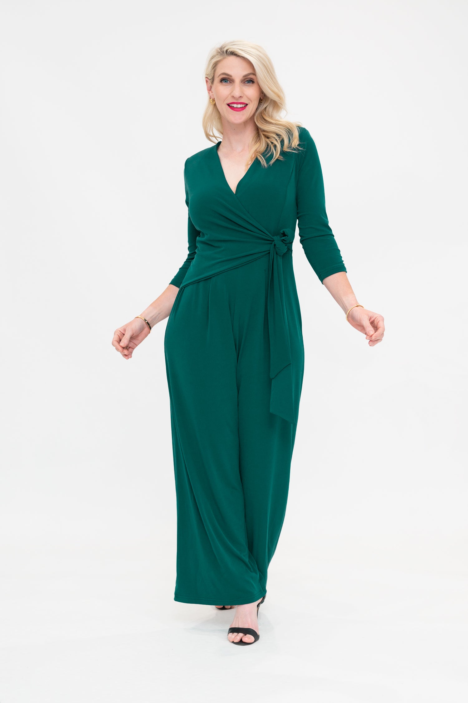 Female model in green wrap jumpsuit. Front view