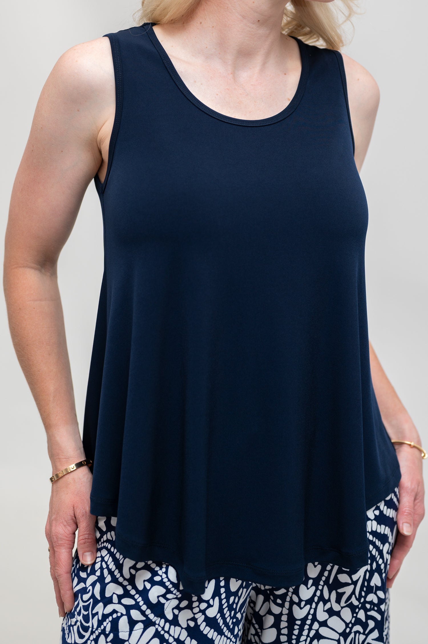 By Samantha Melbourne Erin Swing Singlet. Available in 3 colours. Made in Australia. Model wears Erin Singlet in Navy. Erin Singlet is sleeveless, features Round Crew Neck, Swing style and Relaxed fit, Hip length. Singlet is tucked ino By Samantha Melbourne Palazzo Pants. Closeup