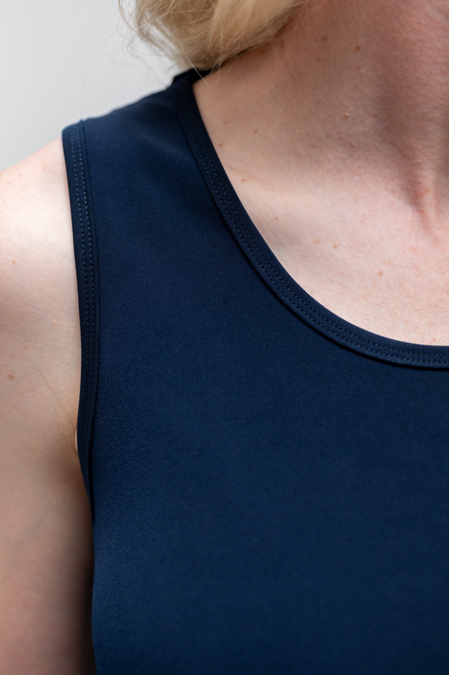 By Samantha Melbourne Erin Swing Singlet. Available in 3 colours. Made in Australia. Model wears Erin Singlet in Navy. Erin Singlet is sleeveless, features Round Crew Neck, Swing style and Relaxed fit, Hip length. Singlet is tucked ino By Samantha Melbourne Palazzo Pants. Closeup