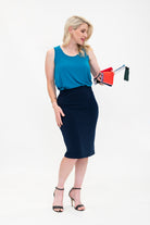 By Samantha Melbourne Erin Swing Singlet. Available in 3 colours. Made in Australia. Model wears Erin Singlet in Blue. Erin Singlet is sleeveless, features Round Crew Neck, Swing style and Relaxed fit, Hip length. Singlet is tucked and paired with By Samantha Melbourne Andy Pencil Skirt in Navy