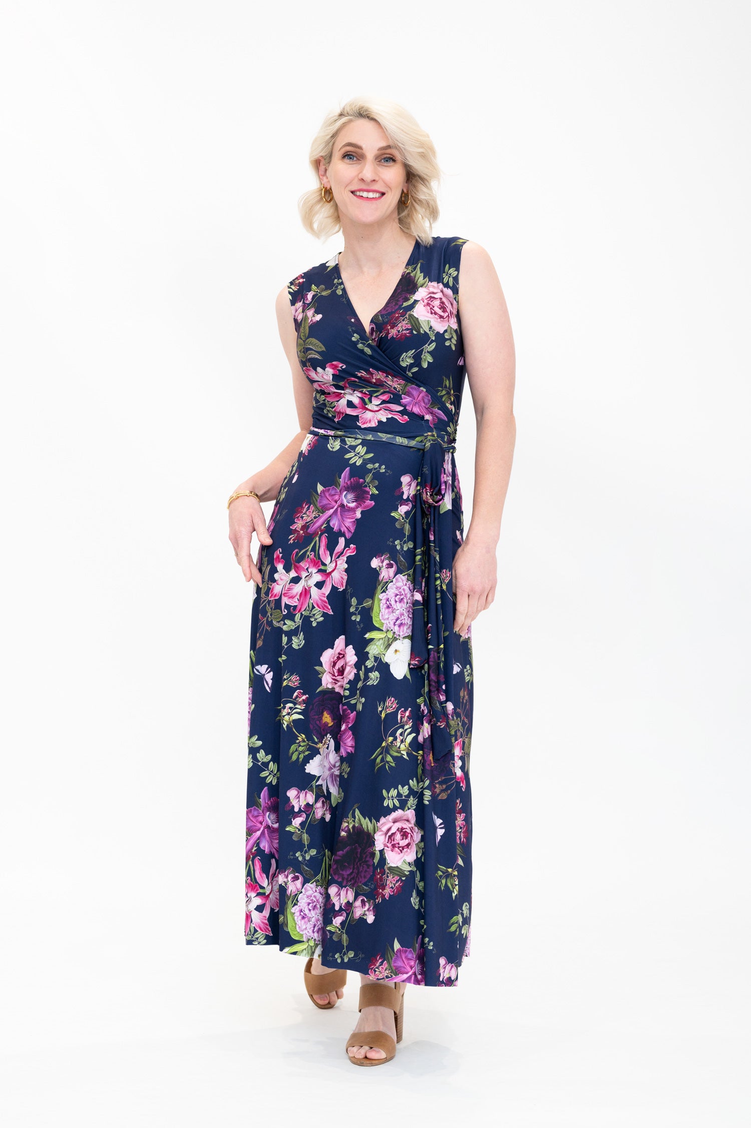 Model wearing the Hazel floral wrap dress by By Samantha Melbourne. Curve-friendly fit with a deep navy base and pink botanical print.