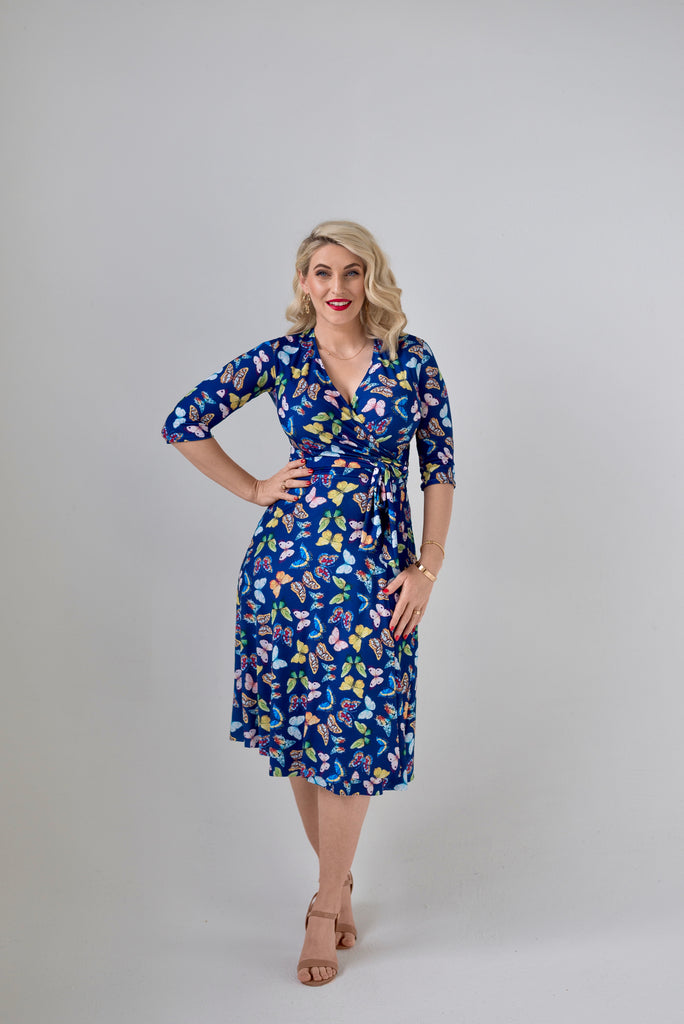 Butterfly themed  Wrap dress is available in regular and plus size dress options - this variant is a knee length  3/4 sleeve 